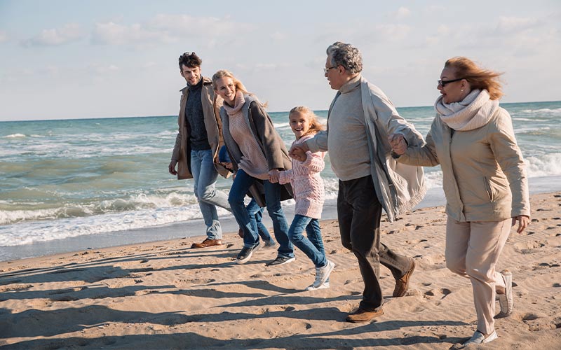 family walking on beach together hand in hand simple retirement strategies