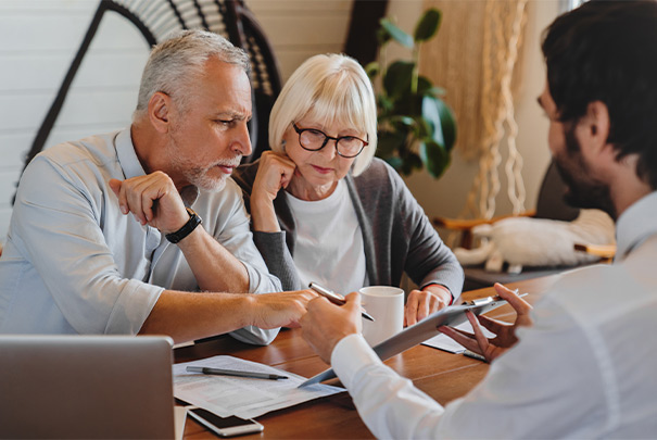 financial advisor meeting with retirees to discuss will you have enough to retire